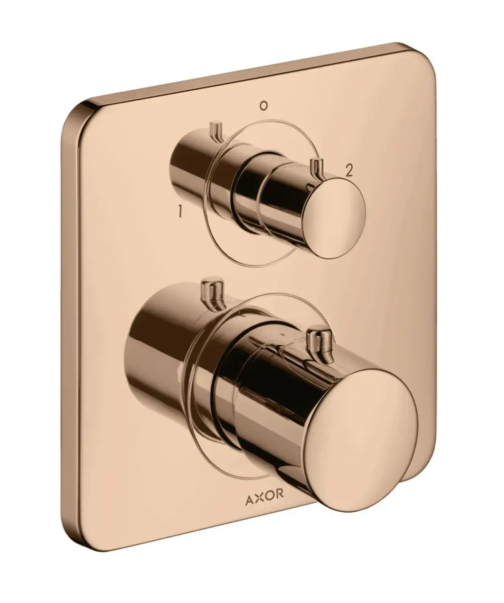 Thermostat mit zwei verchromten Reglern auf quadratischem Wandpanel in Polished Red Gold, hergestellt von AXOR. Anordnung für Ab- und Umstellventil deutlich erkennbar.